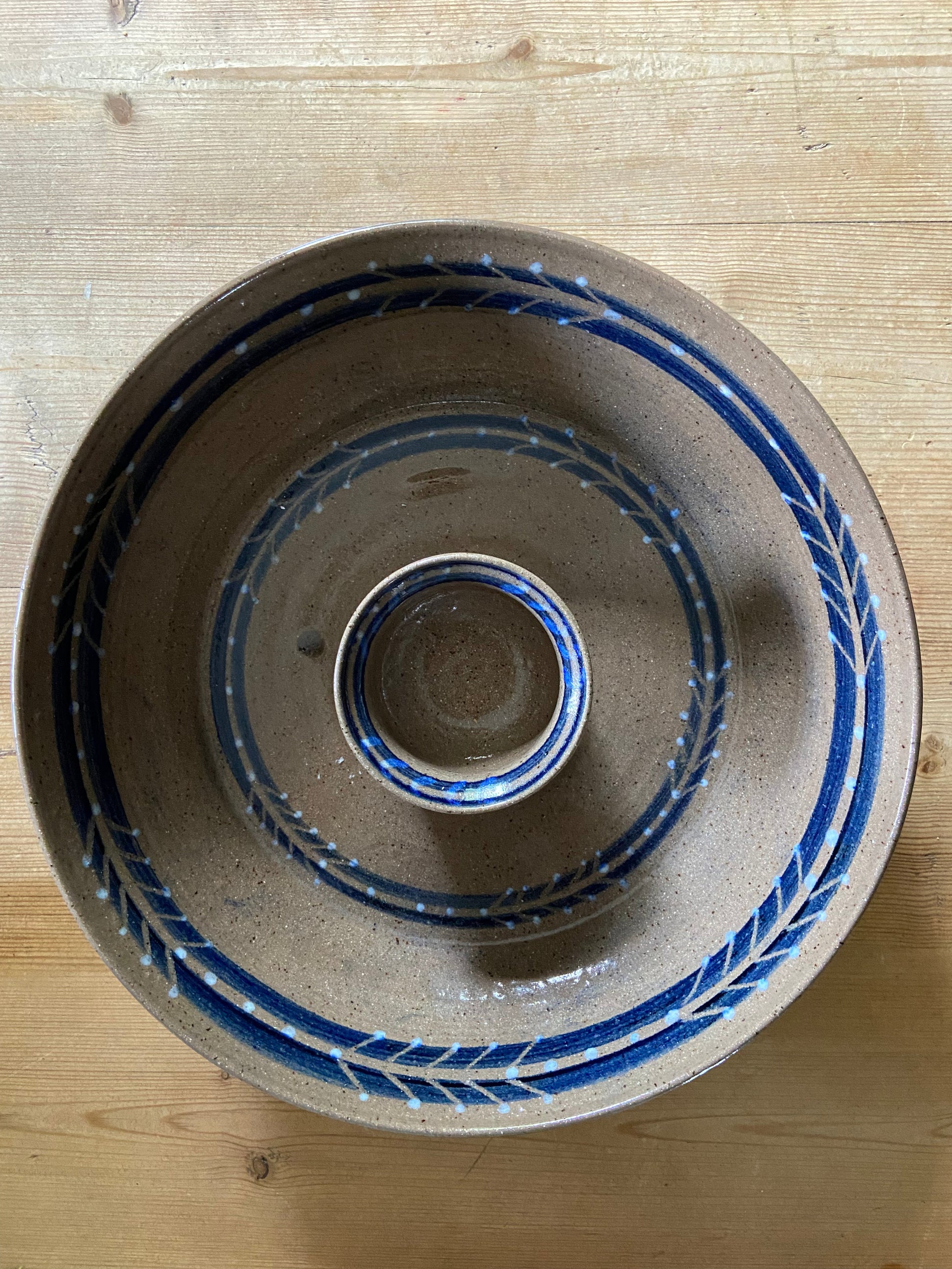 "A handmade blue gray dip bowl, suitable for serving chips and dips or as a decorative piece."