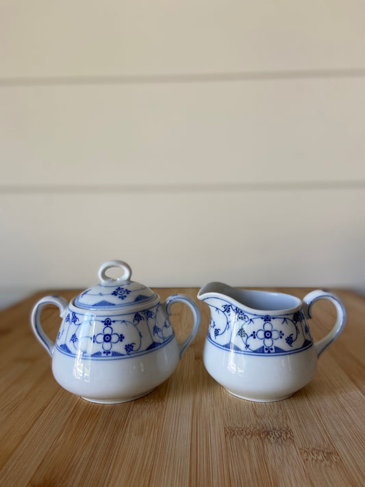 "A charming blue and white sugar and creamer set made in Germany."