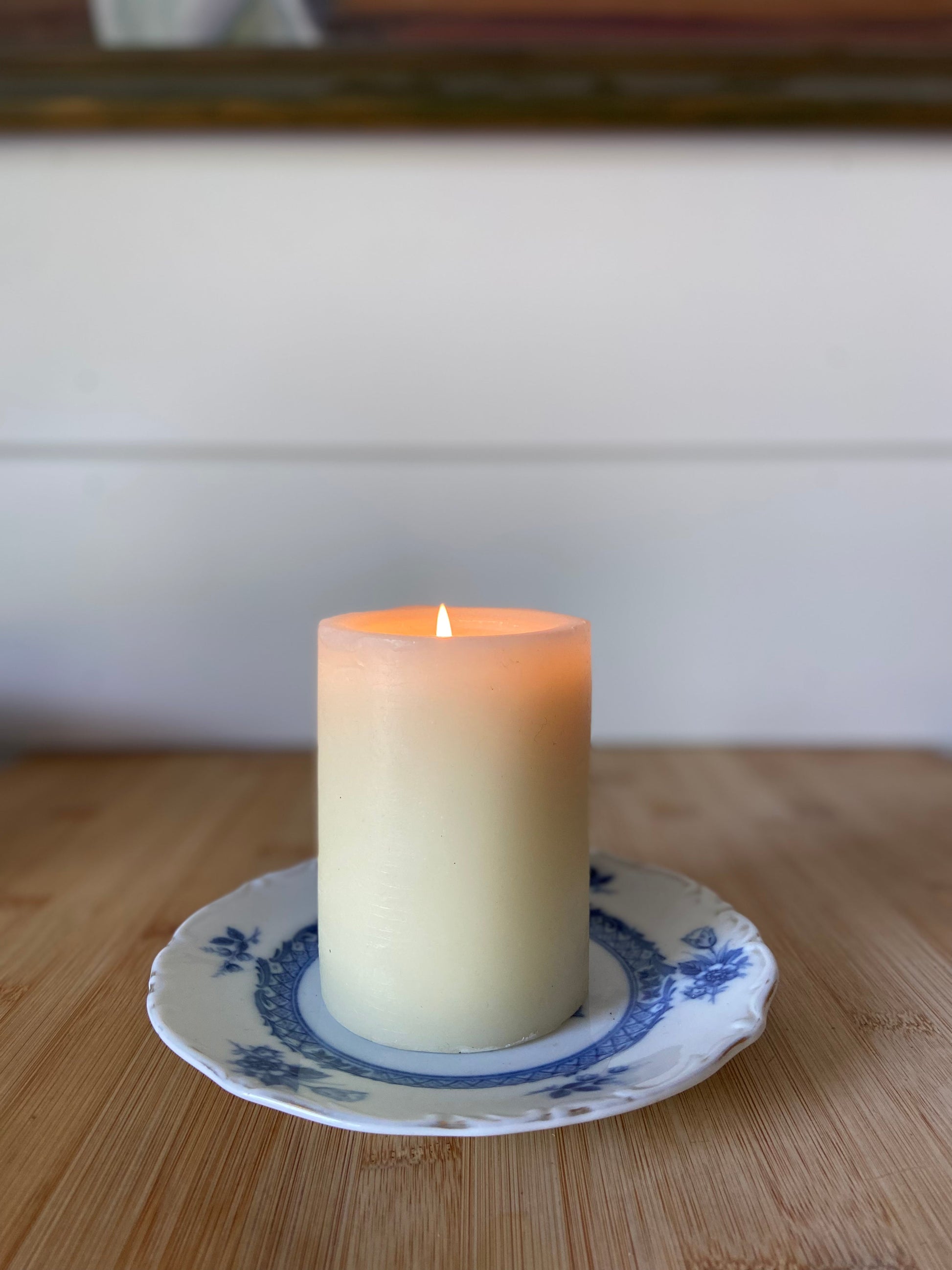 "A single blue and white tea plate, ideal for holding a candle or serving small items."