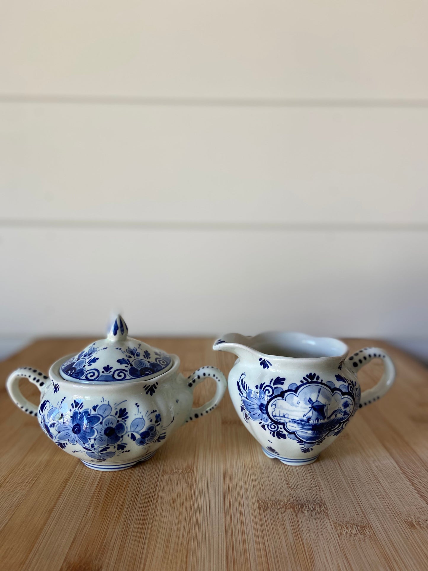 "A handpainted blue and white creamer and sugar set from the Netherlands, dating back to the 60s."