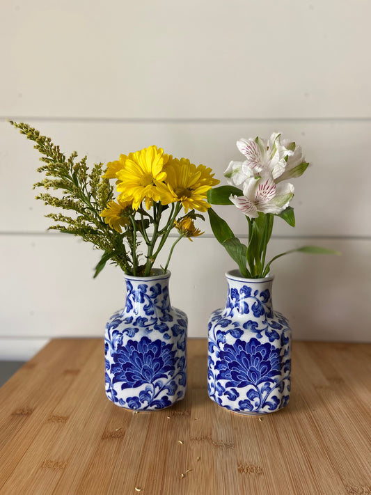 "Two matching blue and white vases, perfect for displaying small bouquets."