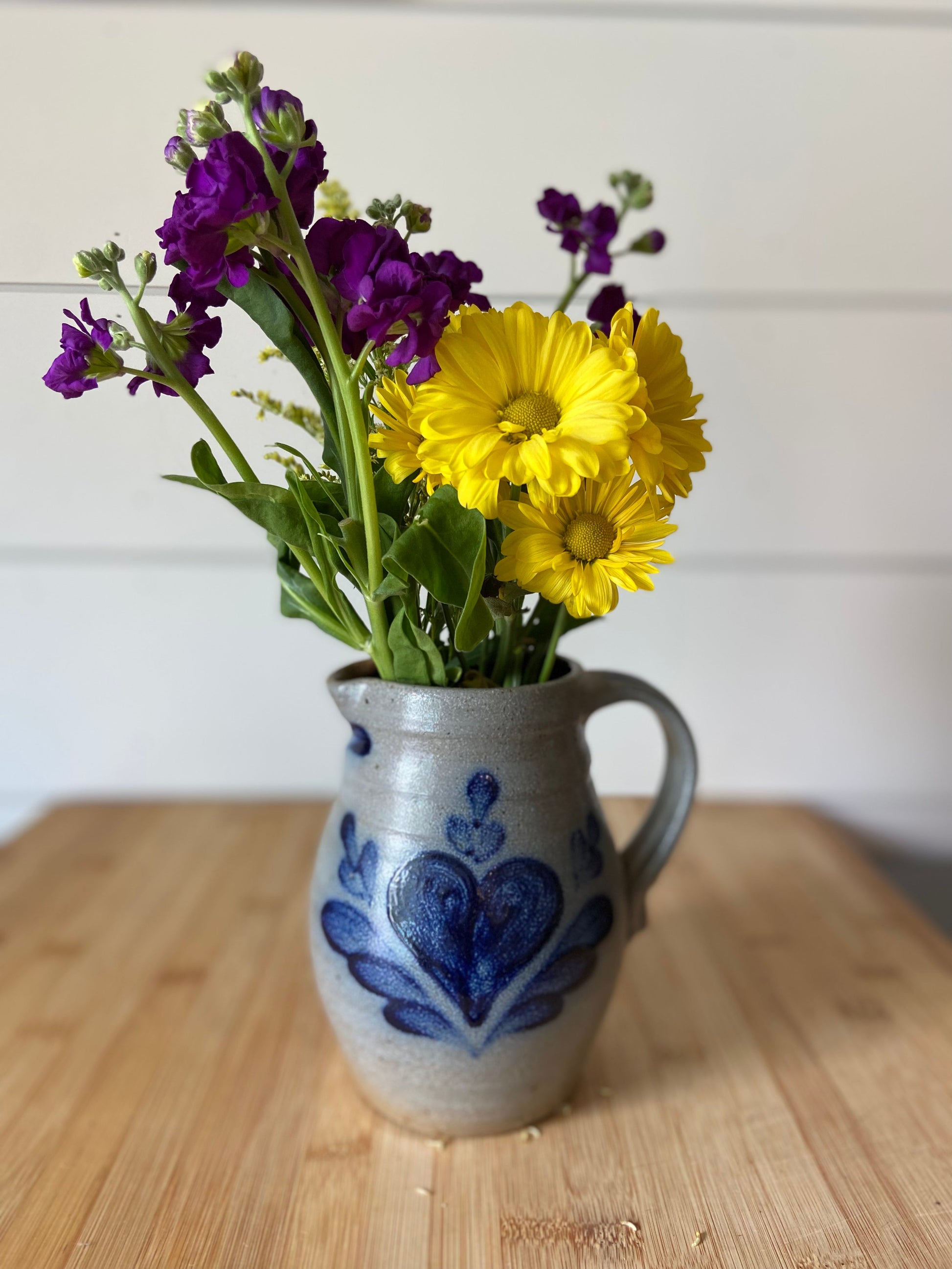 "A handmade salt glazed pitcher from Rowe Pottery, functional as a pitcher or decorative vase."